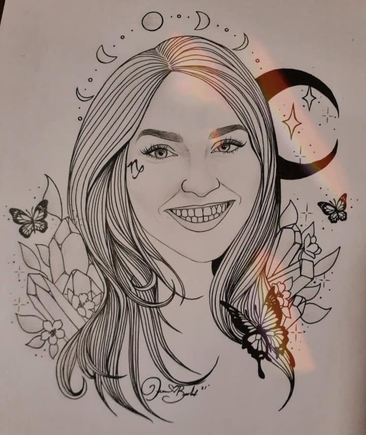 Ink portrait of a grinning woman with long hair, a zodiac glyph on her cheek, a crescent moon and butterflies beside her and flowers at her shoulders