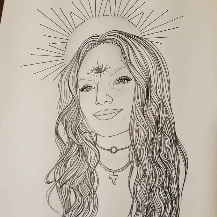 Ink portrait of a smiling woman with long wavy hair and a third eye, a halo of sun rays drawn around her head